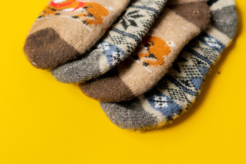 colorful wool socks isolated on yellow background