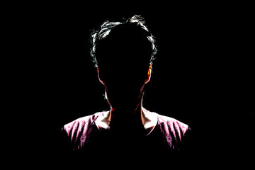 silhouette of man in dark place, anonymous backlit contour a
