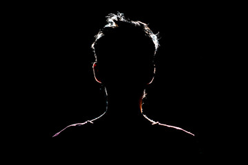 silhouette of man in dark place, anonymous backlit contour a - Powered by Adobe