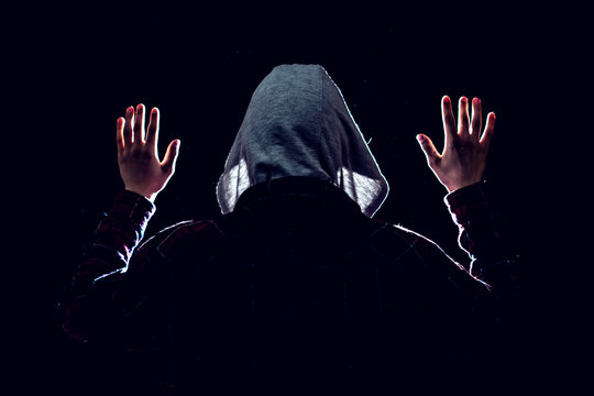 cought by police suspect with raised hands in the dark place at night