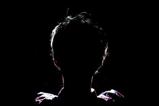 silhouette of man in dark place, anonymous backlit contour a