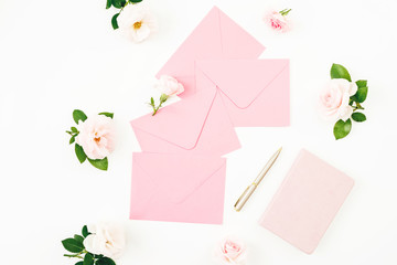 Frame with peonies, eucalyptus, pink envelope and diary with pen on white background. Flat lay, top view.