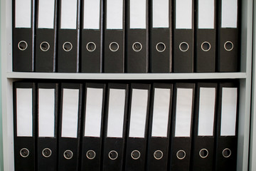 colorful archive folders for documents on the shelves in the office