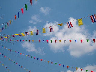 Colorful of flags on blue sky with clouds background in carnival fair