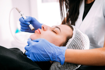 Professional skin care, procedure Microdermabrasion of the facial skin at cosmetic clinic
