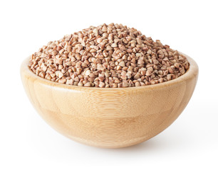 Roasted buckwheat grains in wooden bowl isolated on white background with clipping path
