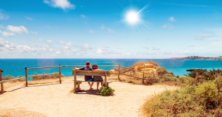 Fototapeta na wymiar couple assis sur un banc face à la mer