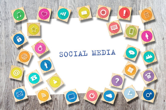 Social media concept with social icons on wooden blocks. Wooden background.