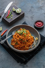 Spicy mee goreng mamak, malaysian or singaporean fried noodles with ketchup and chili