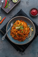 Indian mee goreng or mee goreng mamak, Indonesian and Malaysian cuisine, spicy fried noodles in a plate, top view