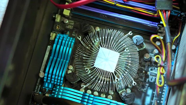 Close-up of hand serviceman uninstall CPU heatsink shows it . Personal computer repair
