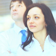 Successful business group in a row smiling and looking up
