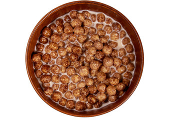 Cereal chocolate balls with milk in a bowl isolated on white background