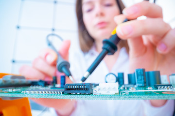 Girl with measuring devices in the electronics laboratory