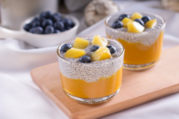Healthy vegetarian vanilla Chia pudding in a glass with fresh berries on coconut milk