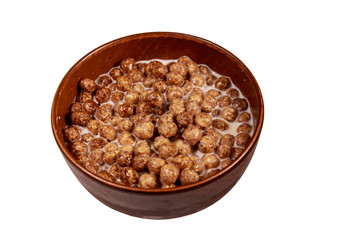 Cereal chocolate balls with milk in a bowl isolated on white background