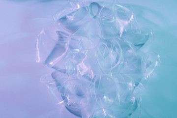 Plastic waste, Plastic cups on light background.