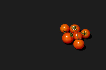 tomatoes on black background