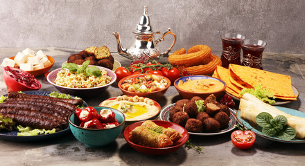 Middle eastern or arabic dishes and assorted meze, concrete rustic background. Falafel. Turkish Dessert Baklava with pistachio. Halal food. Lebanese cuisine