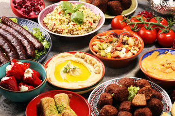 Middle eastern or arabic dishes and assorted meze, concrete rustic background. Falafel. Turkish Dessert Baklava with pistachio. Halal food. Lebanese cuisine
