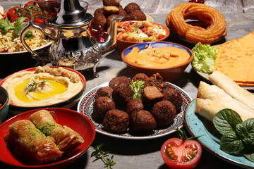 Middle eastern or arabic dishes and assorted meze, concrete rustic background. Falafel. Turkish Dessert Baklava with pistachio. Halal food. Lebanese cuisine