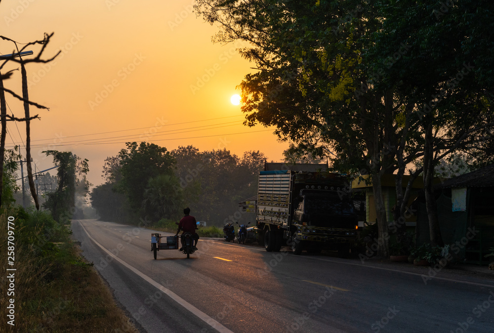 Wall mural motorcycle on asphalt road in countryside and sunshine morning