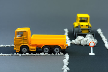 Diorama road construction with yellow construction machinery models. Construction concept....