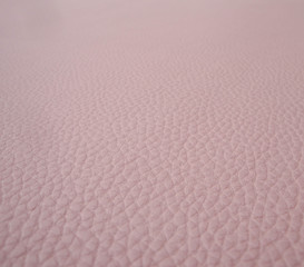 Pink imitation leather, color of the year 2019 - coral pink leather texture background
