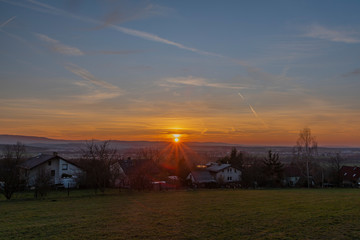 Obraz premium Sunset over Doubravice village with green fields in spring evening