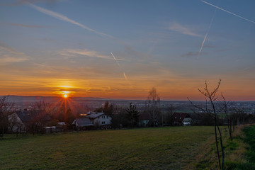 Fototapeta na wymiar Sunset over Doubravice village with green fields in spring evening