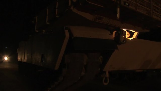 M1 Abrams tank stopping in the desert at night