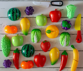 Fototapeta na wymiar Fruits and vegetables toys on wooden background.