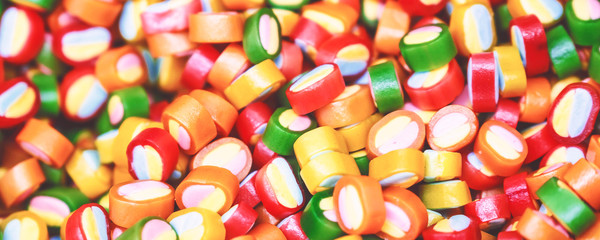 Colorful bright candy, children's joy. The composition of a variety of chocolates by weight in trays.