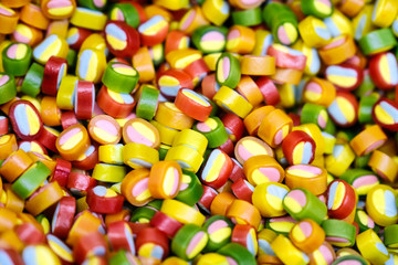 Colorful bright candy, children's joy. The composition of a variety of chocolates by weight in trays.