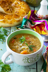 Arabic cuisine. Events Ramadan. Middle Eastern Mung bean soup on wooden table.