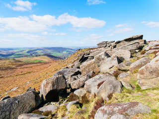 Jumble of large gritstone rocks on the side of Higger Tor in the Derbyshire Peak District.