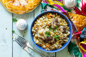 Arabic cuisine. Events Ramadan. Middle Eastern Mashkichiri (porridge made of rice, beef and mung bean) on wooden table. Top view flat lay background. Copy space.