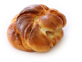 Freshly baked cinnamon bun. Cinnamon roll pastry on white background. Close up stock photo.