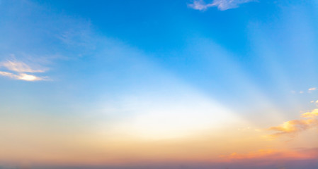 Obraz premium beautiful blue sunset sky with white clouds background, Nature background, yellow and orange tone.
