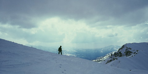 mountains snow winter snowboarder clouds