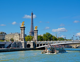 View of Alexandre III bridge and Eiffel Tower from Seine river. Paris, France