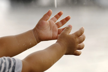 Raining into children's hands.