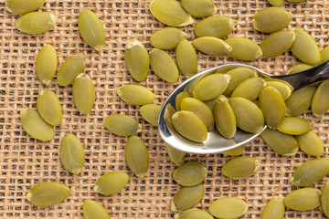 Pumpkin seeds or pips on a dessert spoon