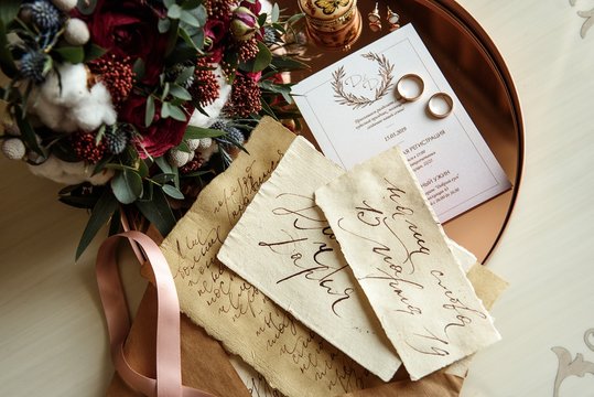 Wedding invitation with wedding rings and flowers