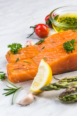 Cold smoked salmon fish fillets on white marble table