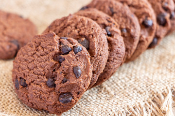 Chocolate chip cookies on sackcloth on the table. Copy space for your text or image.