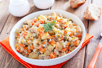 Rice salad with tuna, cherry tomatoes, kidney bean, sweet corn, red onion, spices and fresh parsley. Home made food. Symbolic image. Concept for a tasty and healthy meal. White background. Close up.
