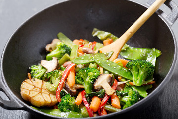 stir fried vegetables in a wok