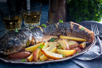 Grilled whole mullet on a wooden table, horizontal