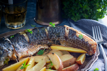Grilled whole mullet on a wooden table, horizontal